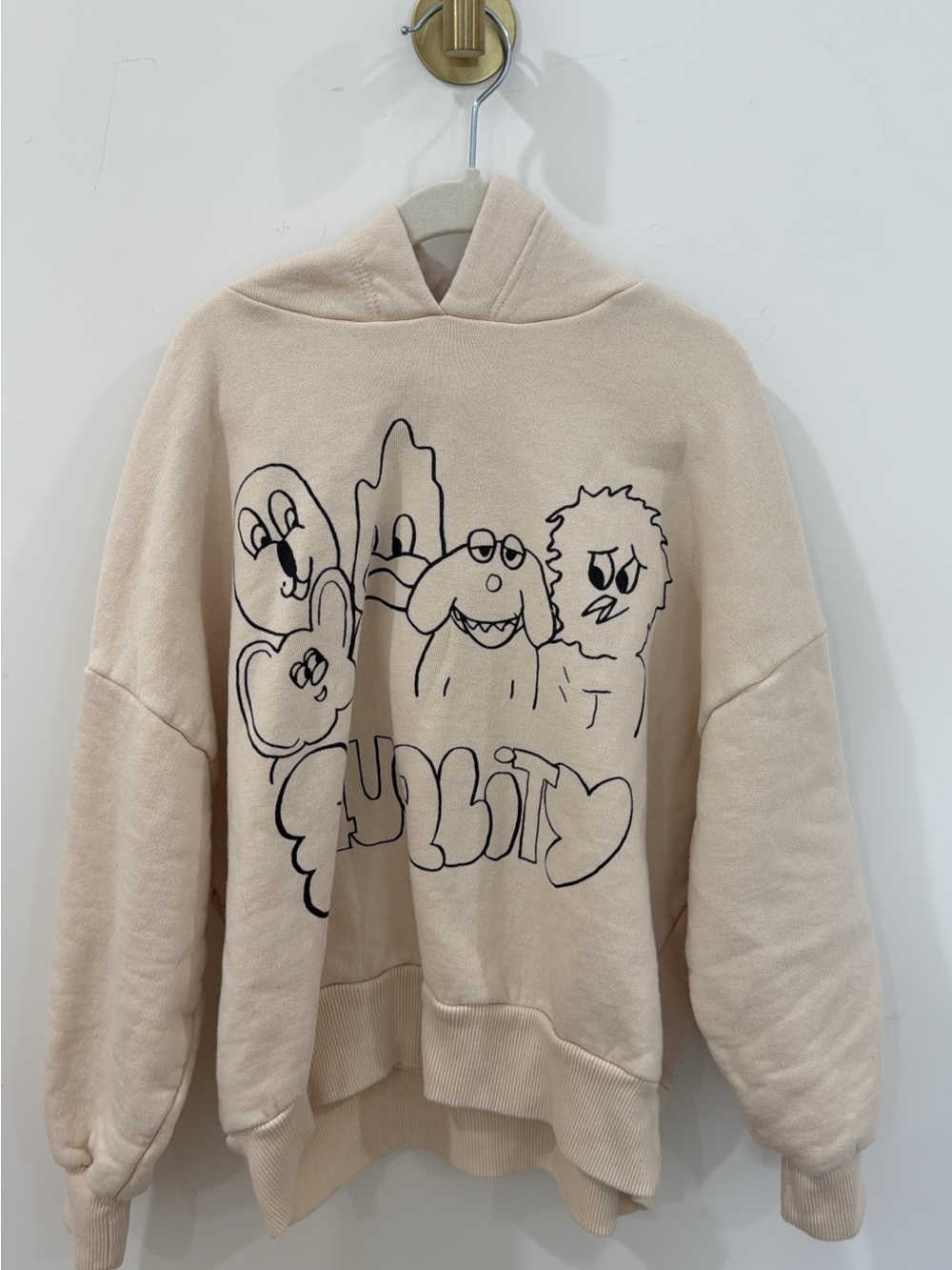 Cream Graphic Hoodie with Black Cartoon Design